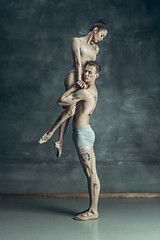 Image showing The young modern ballet dancers posing on gray studio background