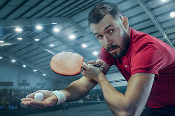 Image showing The table tennis player serving