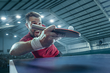 Image showing The table tennis player serving