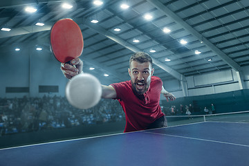 Image showing The table tennis player serving