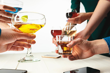 Image showing The male and female hands with exotic cocktails