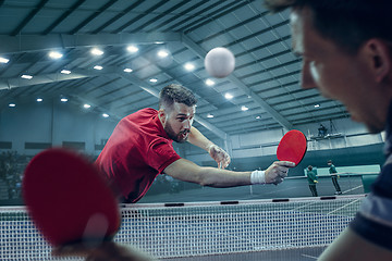 Image showing The table tennis player serving