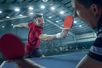 Image showing The table tennis player serving