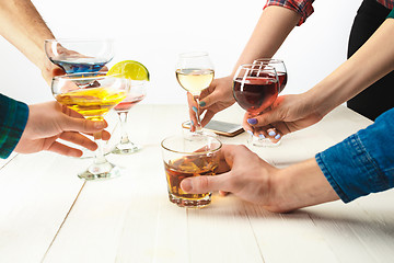 Image showing The male and female hands with exotic cocktails