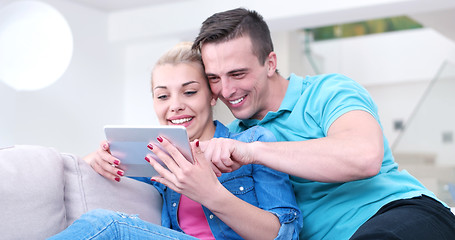 Image showing couple relaxing at  home with tablet computers