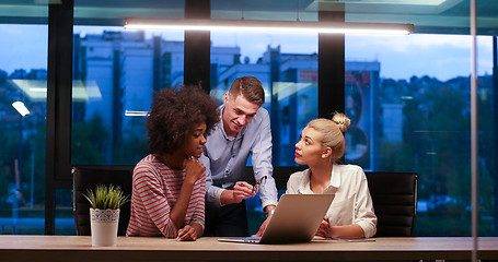 Image showing Multiethnic startup business team in night office