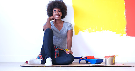 Image showing black female painter sitting on floor