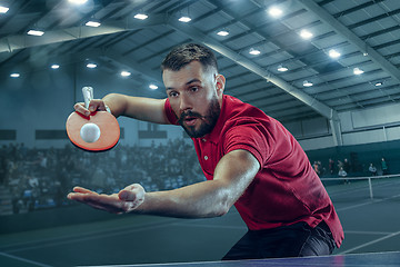 Image showing The table tennis player serving