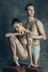 Image showing The young modern ballet dancers posing on gray studio background