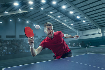 Image showing The table tennis player serving