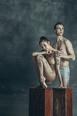 Image showing The young modern ballet dancers posing on gray studio background