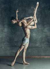 Image showing The young modern ballet dancers posing on gray studio background