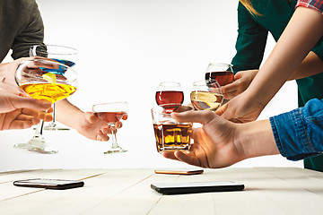 Image showing The male and female hands with exotic cocktails