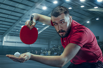 Image showing The table tennis player serving