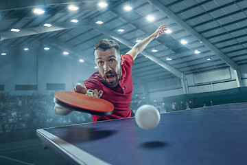 Image showing The table tennis player serving