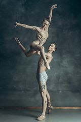 Image showing The young modern ballet dancers posing on gray studio background