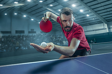 Image showing The table tennis player serving