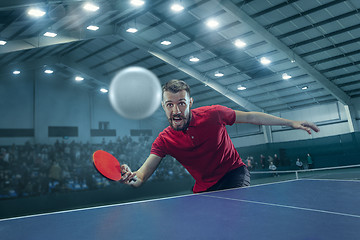 Image showing The table tennis player serving