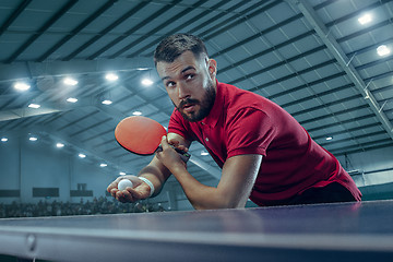 Image showing The table tennis player serving