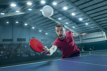 Image showing The table tennis player serving