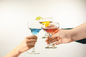 Image showing The male and female hands with exotic cocktails