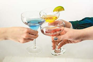 Image showing The male and female hands with exotic cocktails