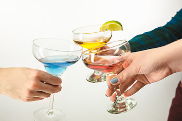 Image showing The male and female hands with exotic cocktails