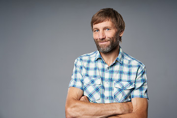 Image showing Studio portrait of smiling mature man in checkered shirt