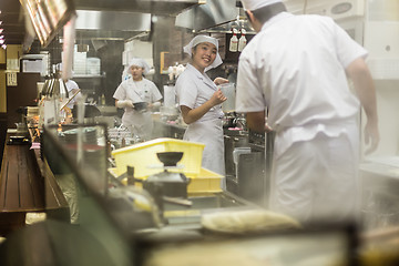 Image showing Japanese Ramen chefs prepare a bowl of traditional home made ramen noodle for customers in Kyoto, Japan.