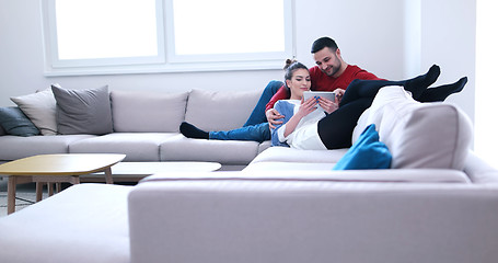 Image showing couple relaxing at  home with tablet computers