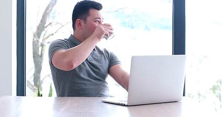 Image showing businessman working using a laptop in startup office