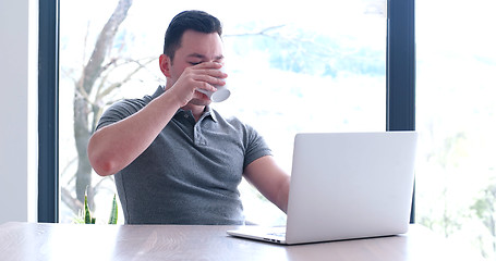 Image showing businessman working using a laptop in startup office