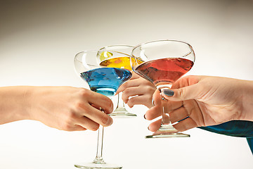 Image showing The male and female hands with exotic cocktails