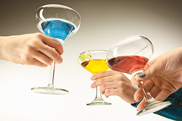 Image showing The male and female hands with exotic cocktails