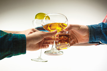 Image showing The male and female hands with exotic cocktails