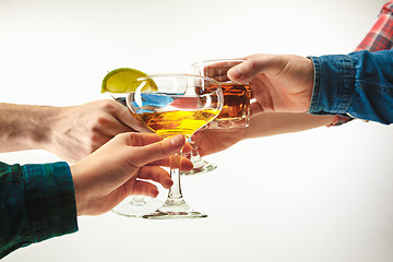 Image showing The male and female hands with exotic cocktails