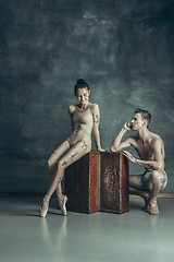 Image showing The young modern ballet dancers posing on gray studio background