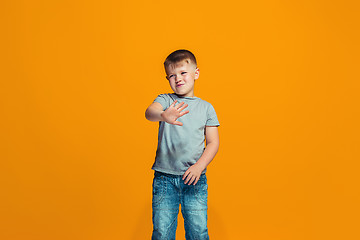 Image showing Young serious thoughtful teen boy. Doubt concept.