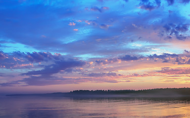 Image showing Amazing Sunset Over The Forested Shore Of The Lake