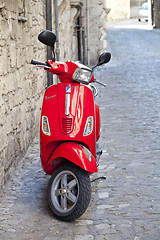 Image showing Rome, Italy - March 31, 2019: Red Scooter Vespa parked on old st