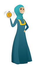 Image showing Muslim business woman holding alarm clock.