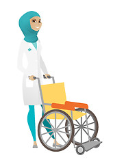 Image showing Muslim female doctor pushing wheelchair isolated on white background.