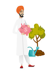 Image showing Hindu farmer holding a piggy bank.