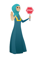 Image showing Muslim business woman holding stop road sign.