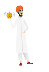 Image showing Hindu businessman holding alarm clock.