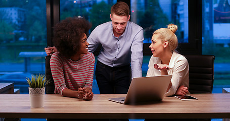 Image showing Multiethnic startup business team in night office