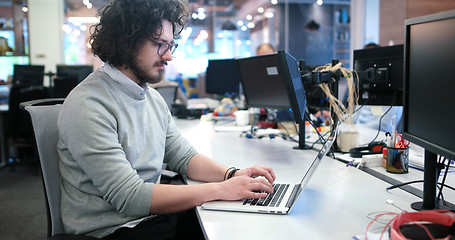 Image showing businessman working using a laptop in startup office