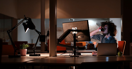 Image showing Tired businessman working late