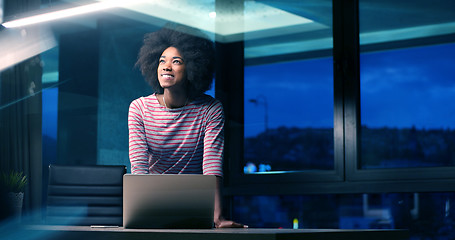 Image showing black businesswoman using a laptop in night startup office