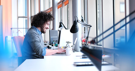 Image showing businessman working using a laptop in startup office